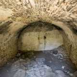 Varchiamo l'accesso, incontrando sulla destra il primo stabile del sito, sviluppato su due livelli. Il piano terra � un fresco stanzone lungo una decina di metri, probabilmente creato come deposito, dove ignoti hanno gettato buste di plastica e una tanica di ferro